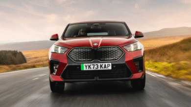 2025 BMW iX2 front view in blue with coupe-like SUV styling